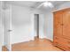 Bright bedroom featuring wood-look floors and a large closet, complemented by modern ceiling fan at 618 Meadow Park Dr, Minneola, FL 34715