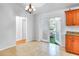 Dining area with tile floors, a view of outdoor seating through glass doors, and kitchen counter at 618 Meadow Park Dr, Minneola, FL 34715
