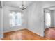 Dining room featuring hardwood floors, a chandelier, and windows with sheer curtains at 618 Meadow Park Dr, Minneola, FL 34715
