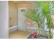Close-up of a white-framed screen door, surrounded by lush tropical plants and colorful accents at 618 Meadow Park Dr, Minneola, FL 34715