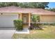 Close up exterior showcasing the front entrance with a well maintained yard and driveway at 618 Meadow Park Dr, Minneola, FL 34715