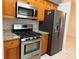 Kitchen featuring stainless steel appliances, including a gas range, microwave and refrigerator, with tiled flooring at 618 Meadow Park Dr, Minneola, FL 34715