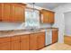 Shows kitchen with granite countertops, tile floors, and wooden cabinets at 618 Meadow Park Dr, Minneola, FL 34715