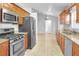 Well-equipped kitchen features stainless steel appliances, granite countertops, and warm-toned cabinetry at 618 Meadow Park Dr, Minneola, FL 34715