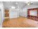 Spacious living room with hardwood floors, a ceiling fan, and a decorative media center at 618 Meadow Park Dr, Minneola, FL 34715