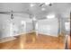 Open-concept living room with hardwood floors, ceiling fan, and access to laundry area at 618 Meadow Park Dr, Minneola, FL 34715
