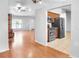 Open floor plan showcasing the living room, kitchen with stainless steel appliances, and front entryway at 618 Meadow Park Dr, Minneola, FL 34715