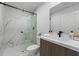 Modern bathroom featuring a sleek glass shower with marble-like tile and contemporary fixtures at 6340 Chorus Dr, Mascotte, FL 34753