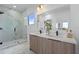 Modern bathroom features double vanity, spacious walk-in shower with glass enclosure, and tile flooring at 6340 Chorus Dr, Mascotte, FL 34753