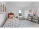Inviting bedroom with a cozy bed, playful decor, and ample natural light, creating a warm and welcoming space at 6340 Chorus Dr, Mascotte, FL 34753