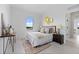 Bright bedroom with a modern accent wall, plush bed, and an inviting view from the window at 6340 Chorus Dr, Mascotte, FL 34753