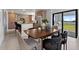 Open dining area flows to the kitchen with stainless steel appliances and natural light from the large sliding doors at 6340 Chorus Dr, Mascotte, FL 34753