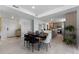 Bright dining area with sleek wooden table, modern chairs, and open access to a modern kitchen space at 6340 Chorus Dr, Mascotte, FL 34753
