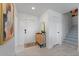 Inviting entryway with minimalist design, featuring neutral tones, wooden accents, and tiled flooring at 6340 Chorus Dr, Mascotte, FL 34753