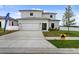 Two story home with neutral paint, a two car garage, and well manicured landscaping at 6340 Chorus Dr, Mascotte, FL 34753
