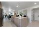 Modern kitchen features an island with white countertops and views to the living area at 6340 Chorus Dr, Mascotte, FL 34753
