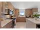 Modern kitchen featuring sleek cabinetry, stainless steel appliances, and bright countertops at 6340 Chorus Dr, Mascotte, FL 34753