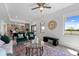 Comfortable living room featuring plush chairs, stylish coffee table, open to the kitchen and dining areas at 6340 Chorus Dr, Mascotte, FL 34753