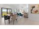 Bright open-concept living area with dining table, stylish decor, and large windows for natural light at 6340 Chorus Dr, Mascotte, FL 34753