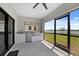 Outdoor kitchen features stainless steel grill, sink, and white countertops with large windows at 6340 Chorus Dr, Mascotte, FL 34753