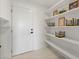 Pantry features bright white walls, tile flooring, and sleek open shelving at 6340 Chorus Dr, Mascotte, FL 34753