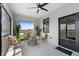 Screened patio with stylish seating and large windows overlooking backyard at 6340 Chorus Dr, Mascotte, FL 34753