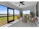 Screened patio with stylish seating and large windows overlooking backyard at 6340 Chorus Dr, Mascotte, FL 34753