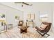 Cozy living room with leather seating, decorative rug, and plenty of natural light at 6384 Chorus Dr, Mascotte, FL 34753