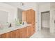 Modern bathroom with double vanity, wood cabinets, and a spacious walk-in shower at 6407 Chorus Dr, Mascotte, FL 34753