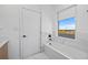 Clean, bright bathroom features a soaking tub with modern fixtures and a window for natural light at 6427 Chorus Dr, Mascotte, FL 34753