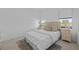 Cozy bedroom with two windows, soft lighting, and neutral-toned bedding at 6427 Chorus Dr, Mascotte, FL 34753