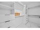 Well-organized walk-in closet with white shelving and drawers at 6427 Chorus Dr, Mascotte, FL 34753