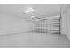 Spacious garage with an automatic door, offering secure parking and extra storage at 6427 Chorus Dr, Mascotte, FL 34753