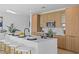 Bright kitchen featuring wood cabinets, stainless steel appliances and a large center island with bar stools at 6427 Chorus Dr, Mascotte, FL 34753
