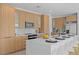 Modern kitchen with light wood cabinetry, stainless steel appliances and a center island with seating at 6427 Chorus Dr, Mascotte, FL 34753
