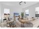 Bright and airy living room featuring comfortable seating, large windows and a neutral color palette at 6427 Chorus Dr, Mascotte, FL 34753