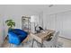 Home office with blue velvet chair, wooden desk and decorative shelving at 6427 Chorus Dr, Mascotte, FL 34753