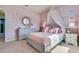 A stylish pink bedroom featuring a canopy bed, butterfly decals, and accent lighting at 7054 Painted Bunting Way, St Cloud, FL 34773