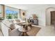 Inviting living room with an L-shaped sofa, neutral tones and a view of lush greenery outside at 7054 Painted Bunting Way, St Cloud, FL 34773