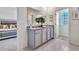 Bright bathroom featuring double sinks, granite countertops, and a view into the main bedroom at 7059 Painted Bunting Way, St Cloud, FL 34773