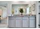 Modern bathroom featuring a double vanity with granite countertop and updated fixtures at 7059 Painted Bunting Way, St Cloud, FL 34773