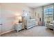 Cozy Bedroom with striped accent wall, modern crib, and soft decor at 7059 Painted Bunting Way, St Cloud, FL 34773