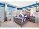 Sports themed bedroom featuring a large window and striped accent walls at 7059 Painted Bunting Way, St Cloud, FL 34773