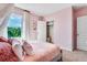 Bedroom with pink accents, plush bedding, and natural light from the window at 7059 Painted Bunting Way, St Cloud, FL 34773
