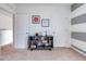 Bedroom with striped accent wall, modern shelving, and neutral decor at 7059 Painted Bunting Way, St Cloud, FL 34773