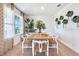 Bright dining area featuring stylish wall decor, a wooden table, and natural lighting at 7059 Painted Bunting Way, St Cloud, FL 34773