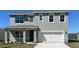 Charming two-story home featuring a two-car garage and a well-maintained landscaped yard at 7059 Painted Bunting Way, St Cloud, FL 34773