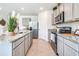 Spacious kitchen featuring stainless steel appliances, granite countertops, and ample cabinet space at 7059 Painted Bunting Way, St Cloud, FL 34773