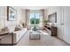 Stylish living room with comfortable seating, modern decor, natural light from the window, and a TV for entertainment at 7059 Painted Bunting Way, St Cloud, FL 34773