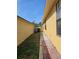 Side yard showcasing a walkway alongside the house, leading to the backyard at 7228 Spring Villas Cir, Orlando, FL 32819